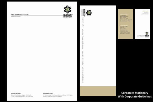 Corporate stationery set laid out on a black background.